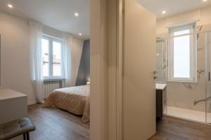 a bedroom with a bed and a walk in shower at IARSERA rooms and apartment in Lucca +45 photos