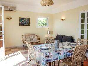 a dining room with a table and chairs at Apartment Les Trois A by Interhome in Saint-Cyr-sur-Mer