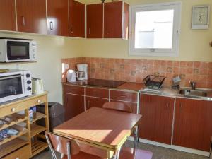 a small kitchen with a table and a microwave at Apartment Les Trois A by Interhome in Saint-Cyr-sur-Mer