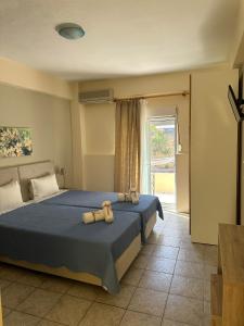 a bedroom with a bed with two pillows on it at Oscar in Kallithea Halkidikis