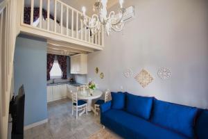 sala de estar con sofá azul y mesa en Nafsika Suites, en Nea Moudania