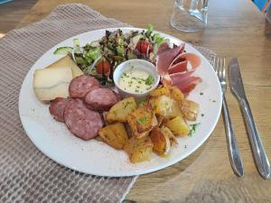 een bord met vleesaardappelen en een salade bij ibis Vesoul in Vesoul