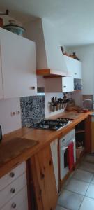 a kitchen with white cabinets and a stove top oven at Bulle de paix en Provence in Bras-dʼAsse +23 photos