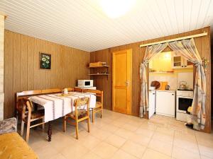 a dining room with a table and a kitchen at Chalet Rosso by Interhome in Balatonmáriafürdő