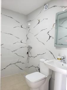 a bathroom with a toilet and a sink at Villa Kapllani in Delvinë +32 photos
