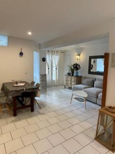 a living room with a table and a couch at Résidence Le Golfe Bleu in Rayol-Canadel-sur-Mer