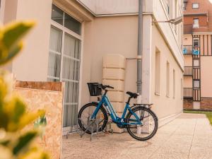 a blue bike parked next to a building at ibis Styles Deauville Villers Plage in Villers-sur-Mer