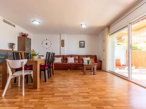 a living room with a table and a couch at Holiday Home Cal 5inc by Interhome in Creixell +41 photos