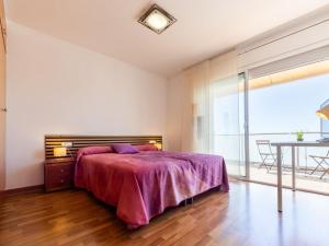 a bedroom with a large bed and a table at Holiday Home Cal 5inc by Interhome in Creixell