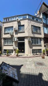 a building with two benches in front of it at Albatros Apart Suite in Istanbul