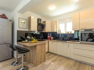 a kitchen with white cabinets and a counter top at Holiday Home Villa Šime by Interhome in Vlašnović