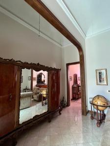 a living room with a large mirror on the wall at Casa nel Liberty in Canicattini Bagni