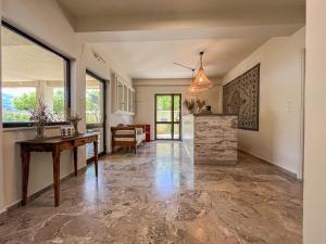 a large living room with a table and a counter at Villa Irene in Poros