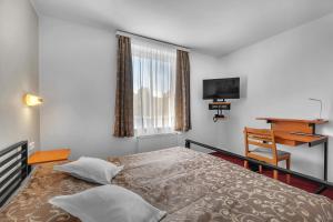 Posteľ alebo postele v izbe v ubytovaní Hotel Za Vodou