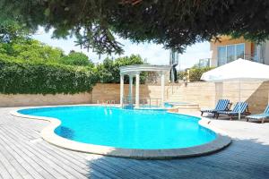 a swimming pool with a gazebo in a yard at Twins Palace ApartHotel in Saints Constantine and Helena +25 photos