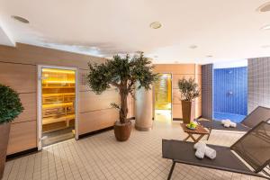 a lobby with potted plants in a building at NH Köln Altstadt in Cologne