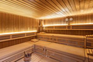 a sauna with benches in a wooden room at NH Köln Altstadt in Cologne