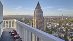 a balcony with a view of a tall building at nhow Frankfurt in Frankfurt/Main