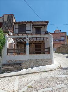 a building with a sign in front of it at CASA ABUELo CAÑI in Arenas de San Pedro