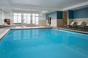 a large swimming pool with blue water at Hyatt Place Canton in Lake Cable