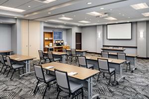 a classroom with tables and chairs and a projection screen at Hyatt Place Canton in Lake Cable