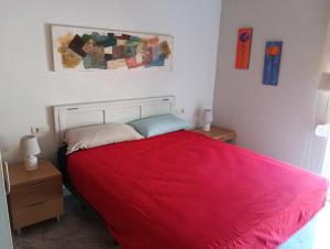 a bedroom with a red bed and two night stands at ADRIJUL in Moraira