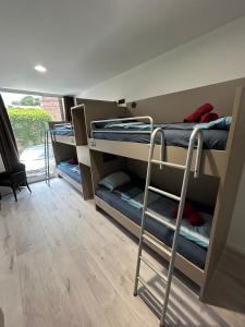 Postel nebo postele na pokoji v ubytování Hostelum