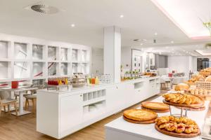 a bakery with a lot of food on display at NH Collection Brussels Centre in Brussels