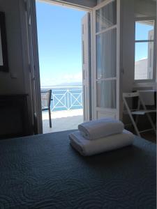 a bedroom with a bed with two towels on it at Ta Adelfia in Pylos