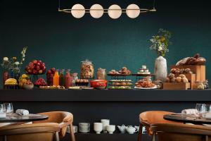 a buffet of food on a table in a restaurant at NH Collection Frankfurt Spin Tower in Frankfurt/Main