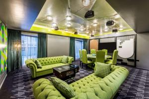 a conference room with green couches and a table at nhow London in London