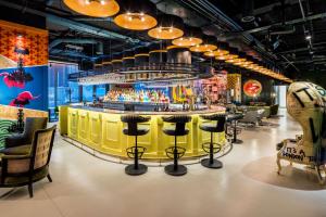 a bar in a restaurant with a yellow counter at nhow London in London