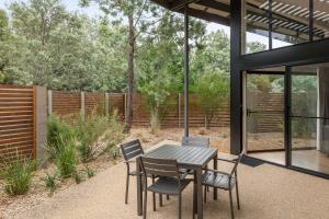 a patio with a table and chairs and a fence at Club Wyndham Seven Mile Beach, Trademark Collection by Wyndham in Cambridge +27 photos