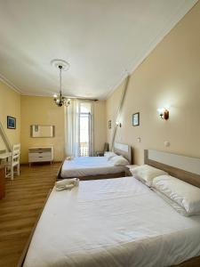 a bedroom with two beds and a room with at Central Guest House in Figueira da Foz