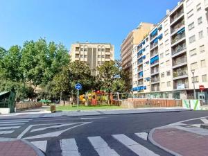 an empty city street with a playground and buildings at El Balcón de Jauregui centro in Salamanca