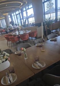 a table in a restaurant with tables and chairs at Cosy Ellipse 2012 Waterfall Midrand in Midrand