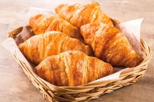 a basket filled with croissants on top of a table at Comfort Hotel Kitakami in Kitakami
