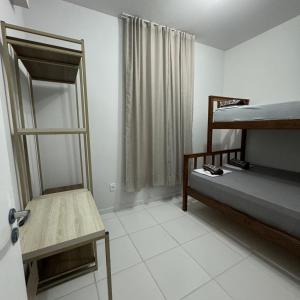 a room with two bunk beds and a mirror at Cantinho de paz in Santarém