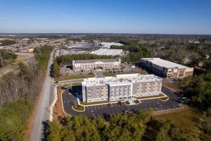 an aerial view of a large white building at Everhome Suites Atlanta Newnan in Newnan