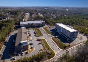 an aerial view of a building with a parking lot at Everhome Suites Atlanta Newnan in Newnan