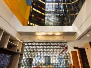 a lobby with a large glass wall in a building at ibis Styles Istanbul Merter in Istanbul