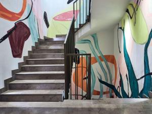 a staircase with a mural on the wall at Hyde Bodrum - Adult Only in Bodrum City