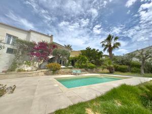 a swimming pool in front of a house at Casita Bouganvilla in Roses