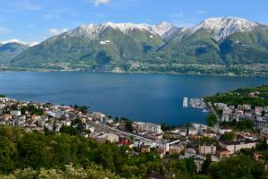 an aerial view of a town on a lake with mountains at Room Casa Jessika in Orselina +11 photos