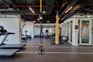 a gym with treadmills and exercise machines at First Class 1BR Apartment in Dubai Hills - next to Dubai Hills Mall in Dubai
