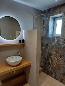 a bathroom with a sink and a mirror at Romeos Studios in Agia Marina Nea Kydonias