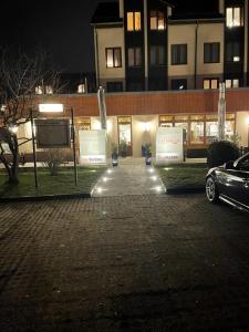 a parking lot in front of a building at night at RESIDENZ AM BERG in Hartmannsdorf
