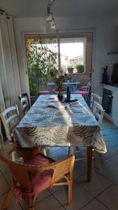 a dining room table with a blue table cloth on it at Chambre "Là Maison Haute" in Faucon