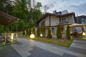 a house with a courtyard in front of it at Karpatski Hotel & Spa in Bukovel