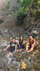 drie mensen in het water in een rivier bij STAY SUKOON Best Resort in Rishikesh in Rishīkesh